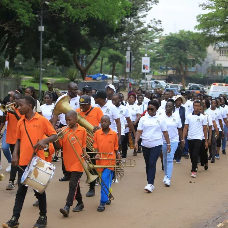 Members of uca matching along band members to pave awareness for the organisation.